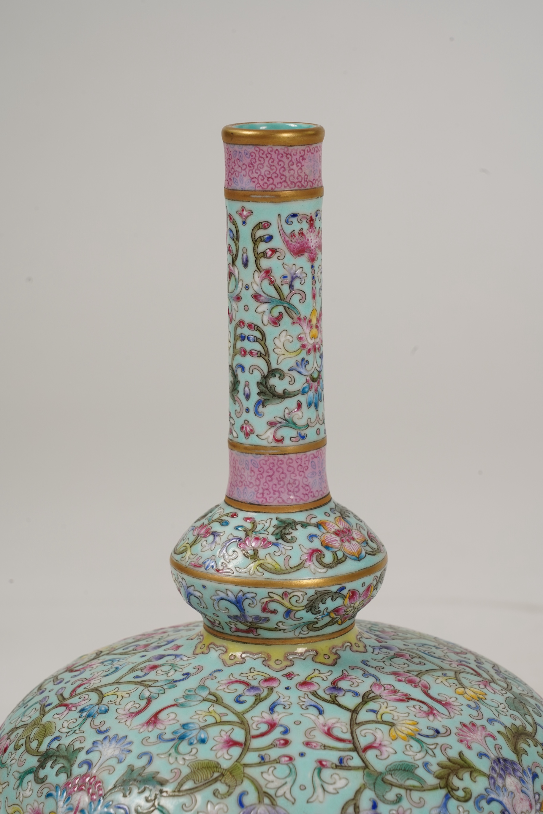 A pair of Chinese famille rose enamelled porcelain bottle vases, Qianlong seal mark to base but Republic Period